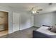 This bedroom has a daybed, a ceiling fan and grey laminate wood flooring throughout at 3153 Morgan Box Ne Ln, Buford, GA 30519