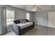 This bedroom features grey laminate wood flooring, a ceiling fan, daybed and two windows at 3153 Morgan Box Ne Ln, Buford, GA 30519