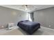 Bedroom featuring a bed with blue bedding, a ceiling fan, a window and a nightstand at 3153 Morgan Box Ne Ln, Buford, GA 30519