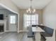 Bright dining area features a modern chandelier, a cushioned dining nook, and a window with natural light at 3153 Morgan Box Ne Ln, Buford, GA 30519