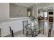 Bright dining room with crown molding, wainscotting and a modern glass table with metal chairs at 3153 Morgan Box Ne Ln, Buford, GA 30519