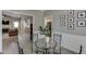Bright dining room with crown molding, wainscotting and a modern glass table with metal chairs at 3153 Morgan Box Ne Ln, Buford, GA 30519
