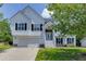 Charming two-story home with white siding, black shutters, and a well-maintained front yard at 3153 Morgan Box Ne Ln, Buford, GA 30519