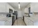 Bright kitchen with white cabinets, granite countertops, stainless steel appliances, and modern lighting at 3153 Morgan Box Ne Ln, Buford, GA 30519