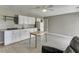 Bright kitchenette with white cabinets, stainless appliances, and dining area at 3153 Morgan Box Ne Ln, Buford, GA 30519