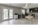The living room has tile floors, glass doors, a ceiling fan, and a stone fireplace with a TV mounted above at 3153 Morgan Box Ne Ln, Buford, GA 30519
