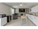 Cozy living room features a fireplace, television, and mini kitchen with white cabinetry at 3153 Morgan Box Ne Ln, Buford, GA 30519