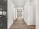 Bright hallway featuring neutral walls, modern baseboards, and beautiful flooring throughout the home at 913 Sundown Pt, Villa Rica, GA 30180