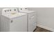 Laundry room with new washer and dryer on wood-style flooring at 913 Sundown Pt, Villa Rica, GA 30180