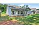 Spacious backyard with a well-maintained lawn, covered patio, and lush green surroundings at 165 Winner St, Acworth, GA 30102