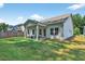 Lush backyard with a covered patio and well-maintained green lawn, perfect for outdoor activities at 165 Winner St, Acworth, GA 30102