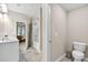 Bathroom featuring dual sinks, white cabinets, toilet, and bathtub with shower at 165 Winner St, Acworth, GA 30102