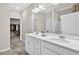Bathroom featuring dual sinks, white cabinets, and access to a walk in closet at 165 Winner St, Acworth, GA 30102