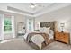 Bedroom featuring a tufted headboard, a ceiling fan, two windows, and an antique mirror at 165 Winner St, Acworth, GA 30102