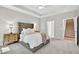 Bedroom features a tufted headboard, a ceiling fan, and a staircase entrance at 165 Winner St, Acworth, GA 30102