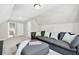 Bonus room with plush carpeting and a large gray sectional couch, perfect for relaxation at 165 Winner St, Acworth, GA 30102