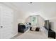 Spacious bonus room with comfortable seating, plush carpeting, and natural light from a window at 165 Winner St, Acworth, GA 30102