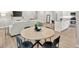 Dining area flows into the kitchen and living room with contemporary decor and hardwood-style floors at 165 Winner St, Acworth, GA 30102