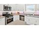 Well-equipped kitchen features stainless steel appliances, gas range, and granite countertops at 165 Winner St, Acworth, GA 30102