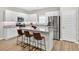 Eat-in kitchen boasts stainless steel appliances, granite countertops, white cabinets, and a breakfast bar at 165 Winner St, Acworth, GA 30102