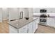 Kitchen island features a breakfast bar, stainless steel appliances, and stylish countertops at 165 Winner St, Acworth, GA 30102
