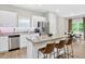 Eat-in kitchen boasts stainless steel appliances, granite countertops, white cabinets, and a breakfast bar at 165 Winner St, Acworth, GA 30102