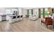 Open-concept living space features modern furniture, wood-look flooring, and lots of natural light at 165 Winner St, Acworth, GA 30102