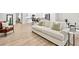 Open-concept living space features modern furniture, wood-look flooring, and lots of natural light at 165 Winner St, Acworth, GA 30102