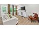 Bright living room features modern furniture, a large TV, and hardwood-style flooring at 165 Winner St, Acworth, GA 30102