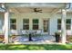 Covered patio with stylish seating, ceiling fan, and a view of the landscaped backyard at 165 Winner St, Acworth, GA 30102