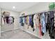 Walk-in closet featuring wire shelving units filled with a wide variety of clothing items at 165 Winner St, Acworth, GA 30102