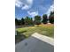 Large backyard with green grass, mature trees, and a wood fence at 2147 Saint Albans Pl, Buford, GA 30519
