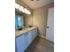 Bright bathroom with dual sinks and granite countertops. Featuring modern lighting and laminate flooring at 2147 Saint Albans Pl, Buford, GA 30519