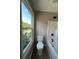 Bathroom with a bathtub, toilet, and bright window at 2147 Saint Albans Pl, Buford, GA 30519