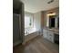 Bright bathroom featuring a tub, shower, and a vanity with granite countertops at 2147 Saint Albans Pl, Buford, GA 30519