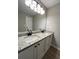 Bathroom featuring double sinks with granite countertops and white cabinets at 2147 Saint Albans Pl, Buford, GA 30519