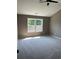 An ample bedroom featuring a ceiling fan, a window bringing in natural light, and plush carpeting at 2147 Saint Albans Pl, Buford, GA 30519