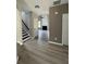Open entryway showcasing modern flooring, a staircase, and a view into the living area with fireplace at 2147 Saint Albans Pl, Buford, GA 30519