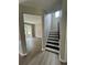 Open concept showcasing modern floors, staircase and a view into a bright living room with natural light at 2147 Saint Albans Pl, Buford, GA 30519