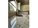 Kitchen featuring granite countertops, subway tile backsplash, and stainless steel sink at 2147 Saint Albans Pl, Buford, GA 30519