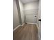 A utility room with wood-look flooring, a single shelf, and hookups for a washer and dryer at 2147 Saint Albans Pl, Buford, GA 30519
