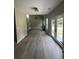 Living room with high ceilings, hardwood floors, a fireplace, and access to the backyard at 2147 Saint Albans Pl, Buford, GA 30519