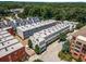 An aerial view showcases the townhome community with its well-maintained landscaping and the surrounding lush green trees at 304 Stonemont Dr, Atlanta, GA 30305