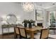 Inviting dining room with decorative chandelier, fireplace, modern decor and plenty of natural light at 304 Stonemont Dr, Atlanta, GA 30305