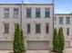 Exterior of brick townhomes with uniform architectural details and private garages at 304 Stonemont Dr, Atlanta, GA 30305