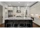 Gourmet kitchen boasts island with seating, stainless steel appliances, and white cabinetry at 304 Stonemont Dr, Atlanta, GA 30305