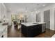 Spacious kitchen with a view to living area features an island with marble countertops and stainless steel appliances at 304 Stonemont Dr, Atlanta, GA 30305