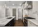 Open kitchen with stainless steel appliances, an island with marble countertops, and bright, modern lighting at 304 Stonemont Dr, Atlanta, GA 30305