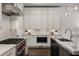 White kitchen features stainless steel appliances, marble countertops and ample cabinet space at 304 Stonemont Dr, Atlanta, GA 30305