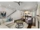 Open-concept living area featuring hardwood floors, a fireplace, modern decor and a kitchen in the background at 304 Stonemont Dr, Atlanta, GA 30305
